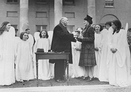 Photograph of President Douglas Hyde with participants in the Cumann Drmadheachta na Sgol competition at the awards ceremony in ras an Uachtarin, 30 March 1939. 