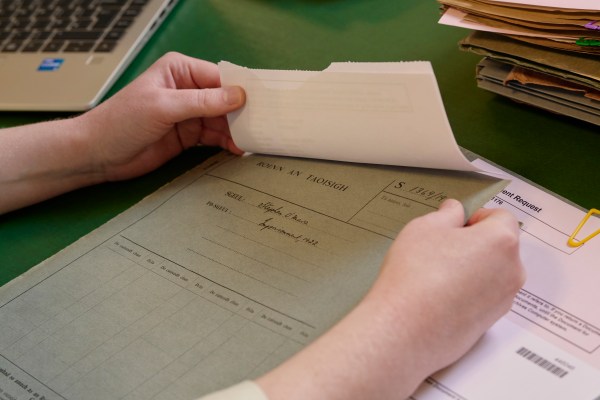 A researcher reading some documents related to the Department of the Taoisigh