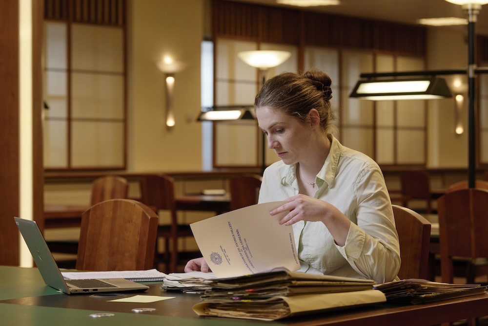 Researcher reviewing paper documents